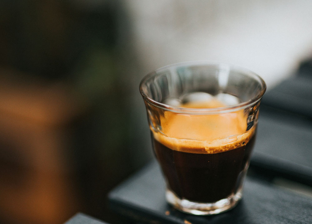 Glass of espresso with a blurred background